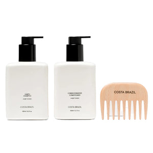 Two bottles of Costa Brazil shampoo and conditioner with a wooden comb on a white background