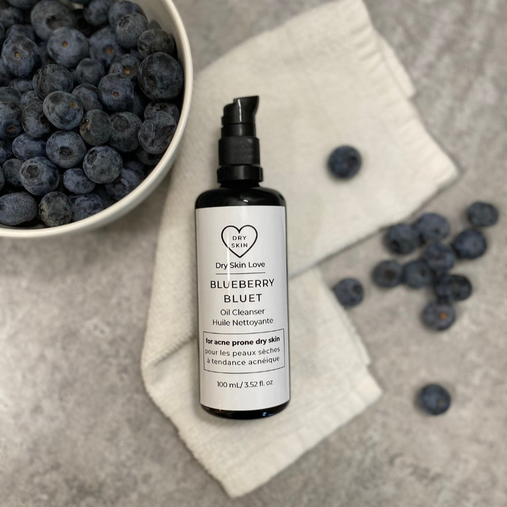 Dry Skin Love Blueberry Oil Cleanser in black glass 100ml bottle with black pump and white label for dry skin, featuring nutrient-rich plant oils, gentle cleansing, and hydration.