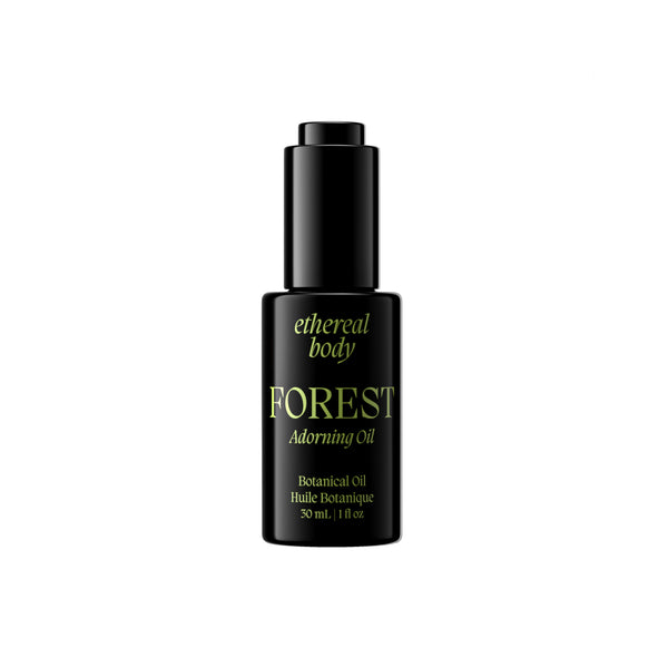 A black bottle of Forest Adorning Oil by Ethereal Body with gold lettering, shown against a solid white background.
