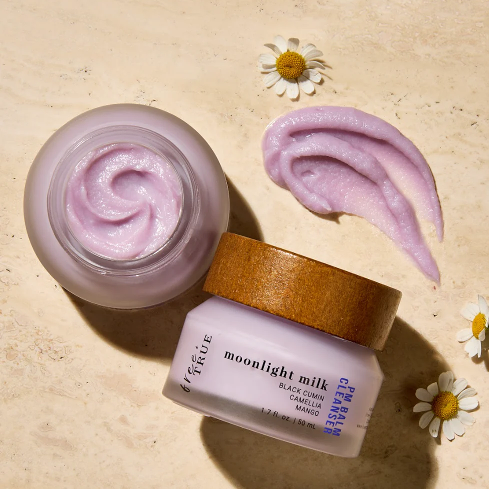 FREE + TRUE Moonlight Milk PM Balm Cleanser in clear glass jar with bamboo wood lid and next is the product's box, on white background