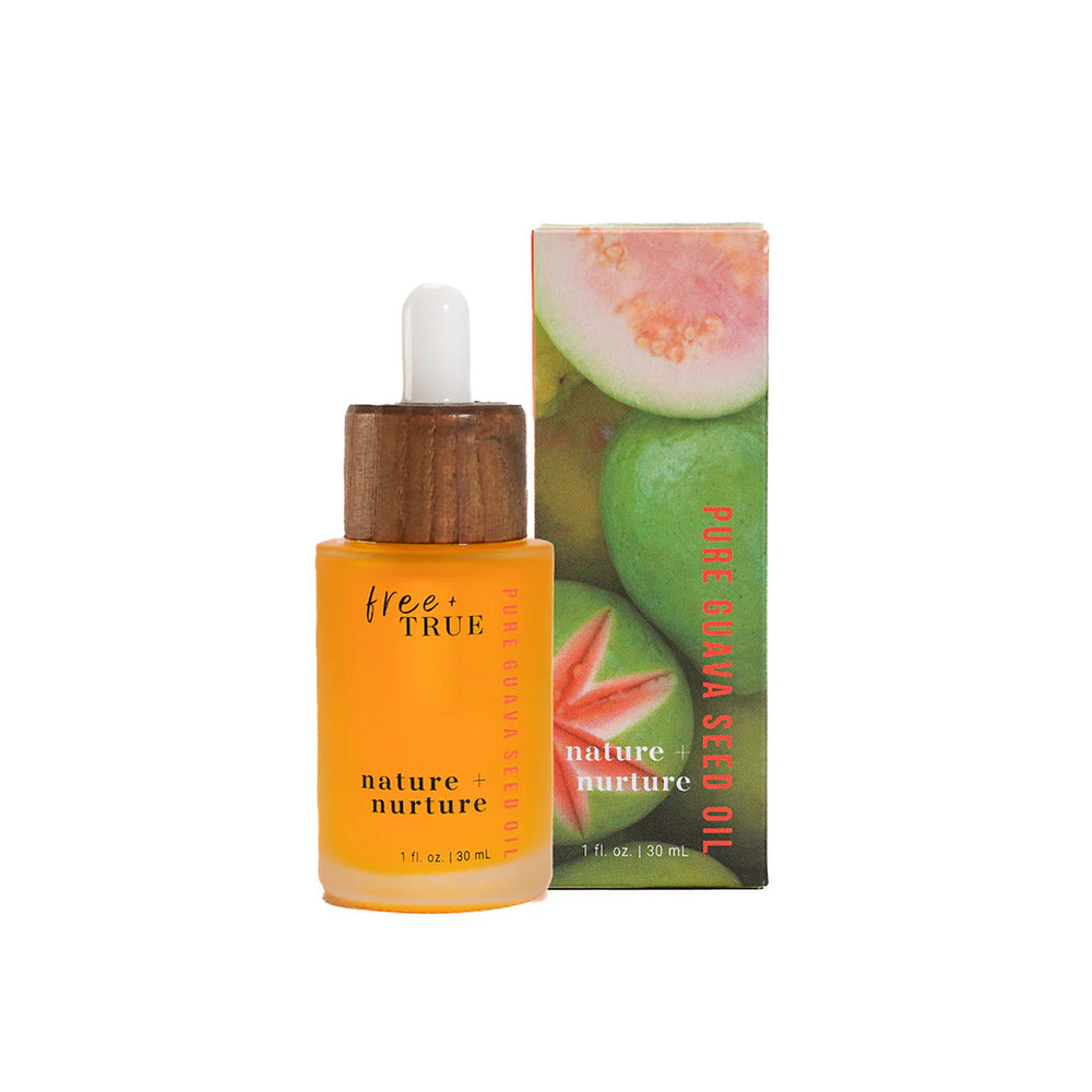 FREE + TRUE Nature + Nurture face oil in clear glass bottle with white and bamboo pipette on white background