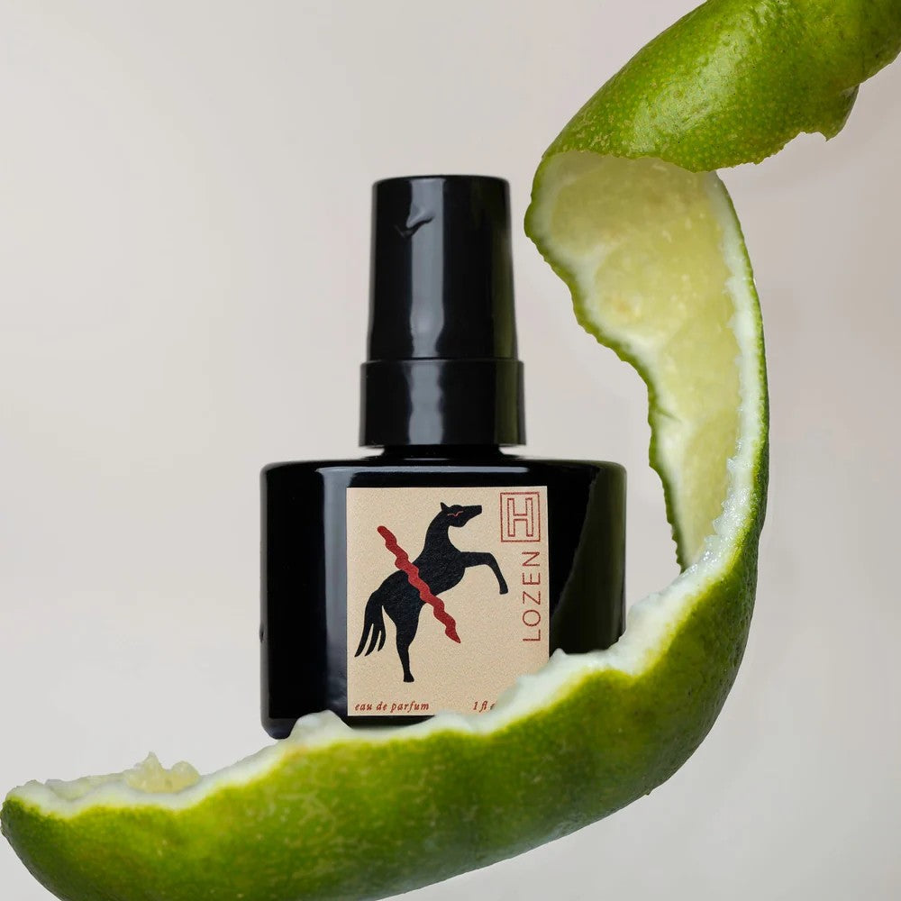 Black perfume bottle with a horse illustration on a beige label against a white background