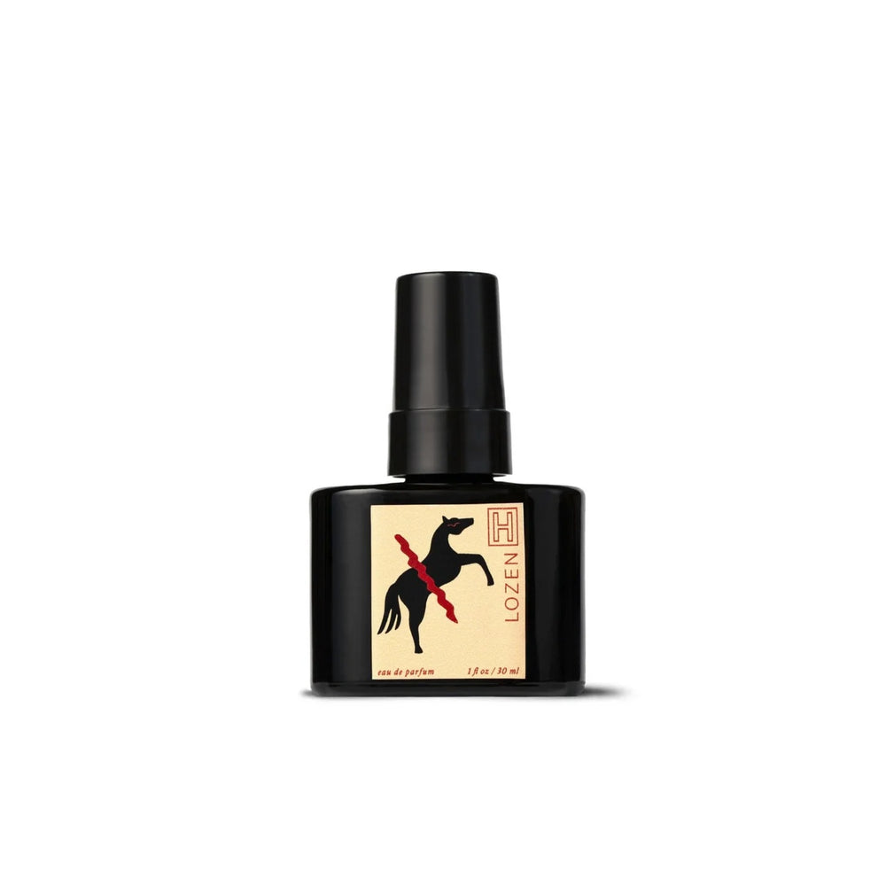 Black perfume bottle with a horse illustration on a beige label against a white background