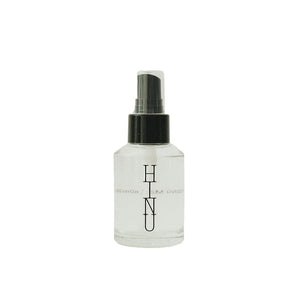 Glass bottle of HINU Hydrating Mist with a minimalist label — a lightweight floral mist designed to hydrate, balance the scalp, and soften hair and skin.