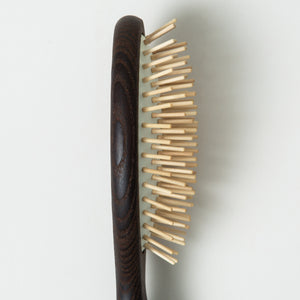 A close up of HINU Wooden Hair Brush's bristles on white background