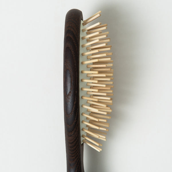 A close up of HINU Wooden Hair Brush's bristles on white background