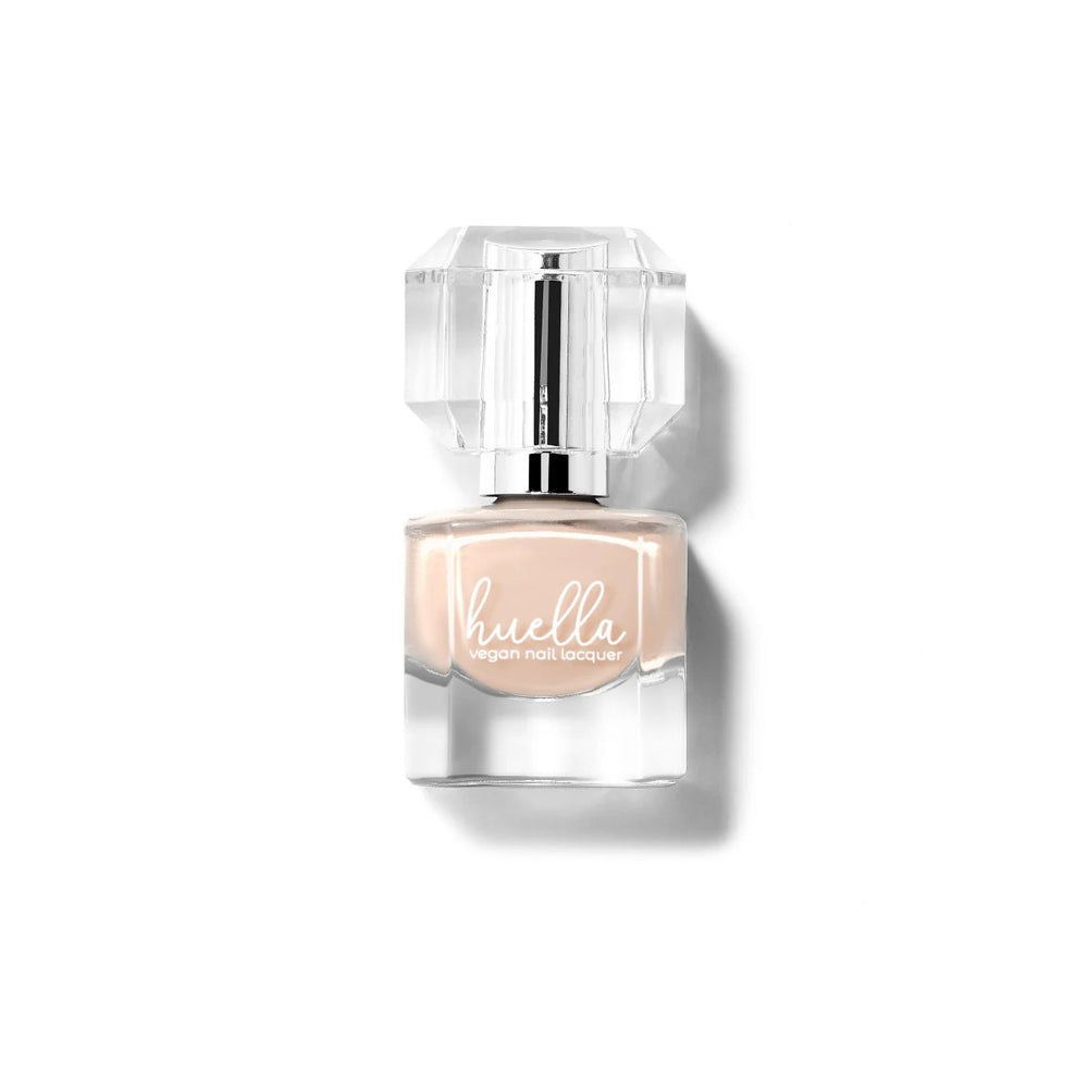 Huella Ballet Blanc nail lacquer in a sheer nude shade, featuring a 15-free, vegan, and chip-resistant formula.