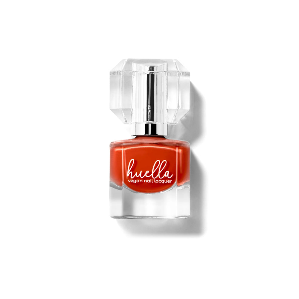 Huella Desert Dream nail lacquer in a warm desert orange shade, featuring a 15-free, vegan, and chip-resistant formula.