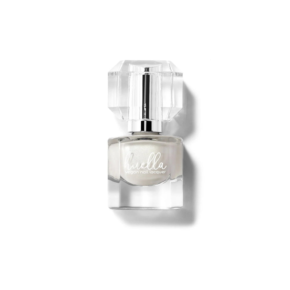 Huella World Is My Pearl nail lacquer in a semi-opaque pearly white, featuring a 15-free, vegan, and chip-resistant formula.