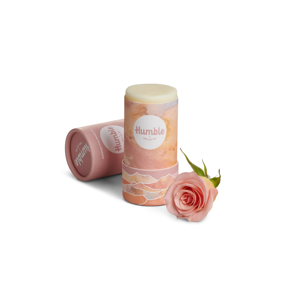 Pink deodorant container with a rose on a white background