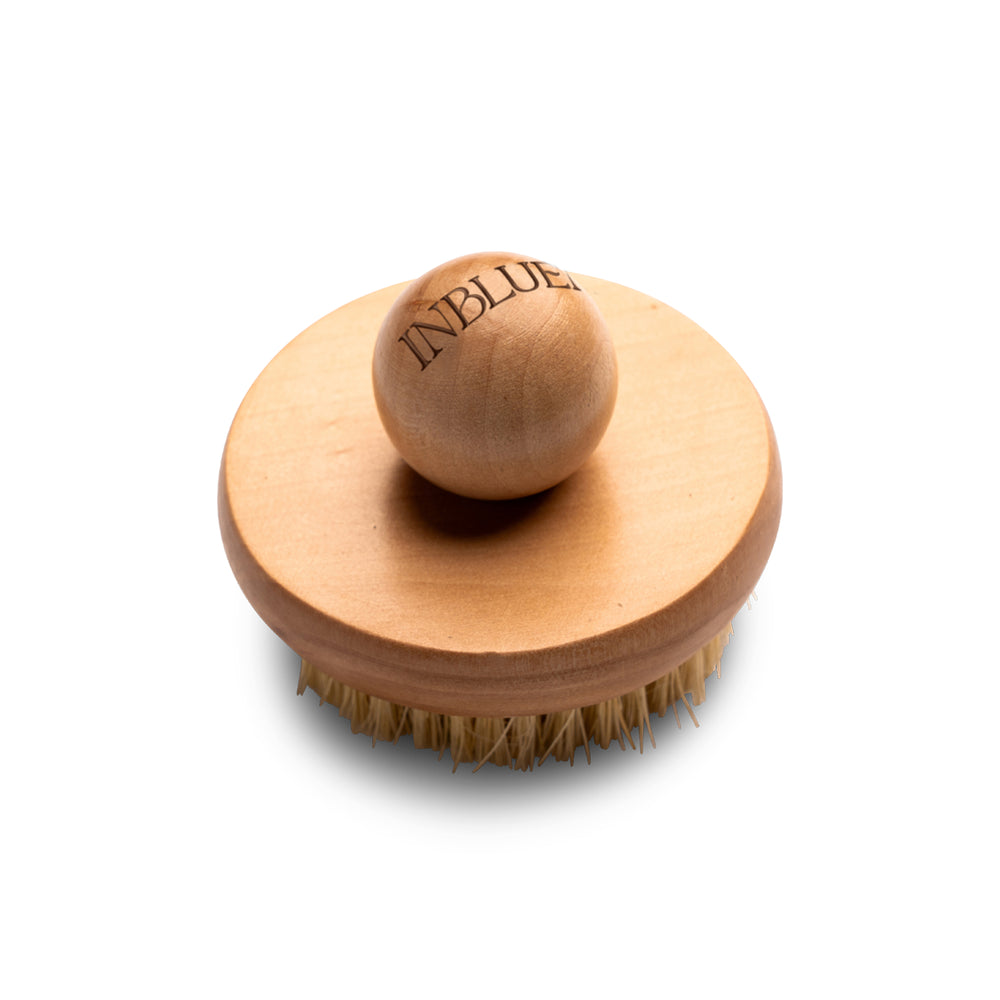 Wooden brush with bristles on a white background. INBLUEM Lotus Wood Body Brush