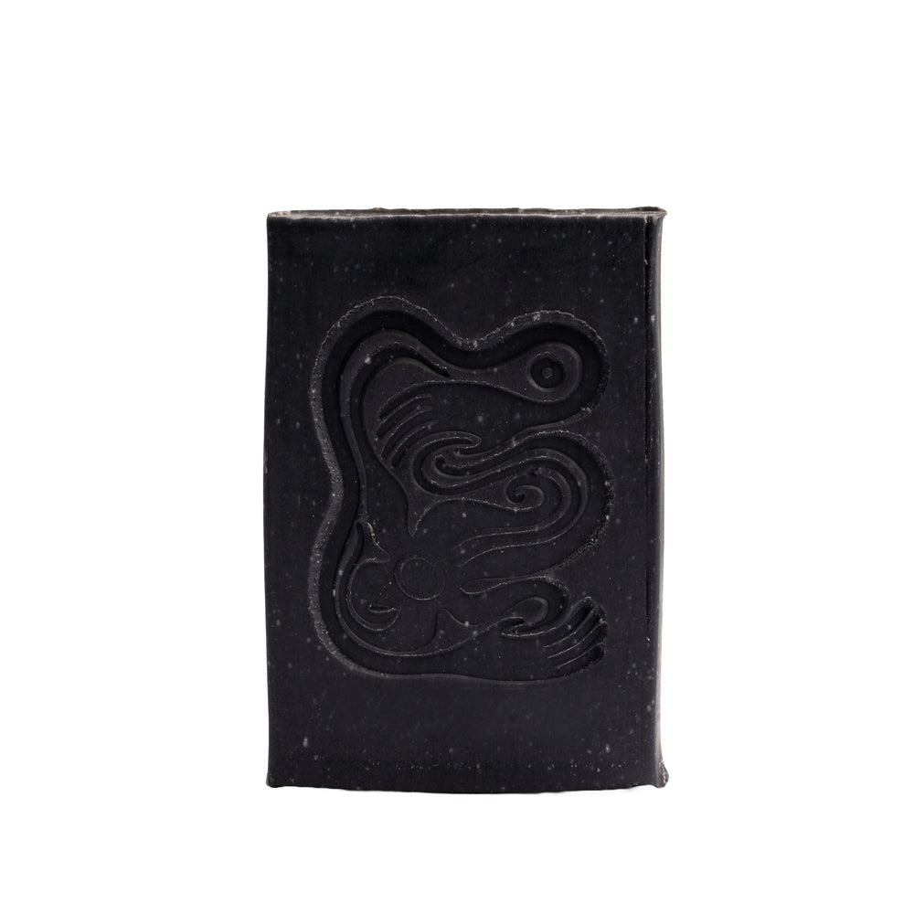 Black soap bar with a logo on a white background. INBLUEM Soul Soap Charcoal & Lemon Myrtle