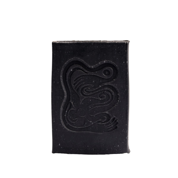 Black soap bar with a logo on a white background. INBLUEM Soul Soap Charcoal & Lemon Myrtle