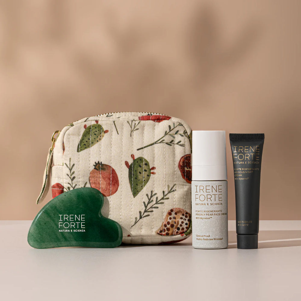 Irene Forte Skincare Age-Defying Day & Night Travel Kit with Prickly Pear Face Cream, Hibiscus Night Cream, jade gua sha, and festive Idda Studio wash bag.