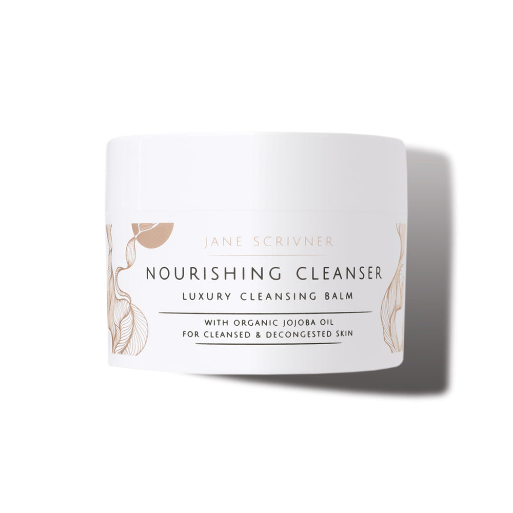 A white cosmetic jar of Jane Scrivner Nourishing Cleanser Luxury Cleansing Balm with gold botanical illustrations and black text, set against a clean white background with a soft shadow.