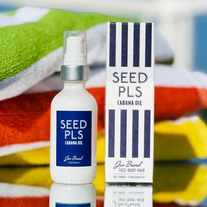 Seed PLS Cabana Oil bottle and packaging on a colorful towel background
