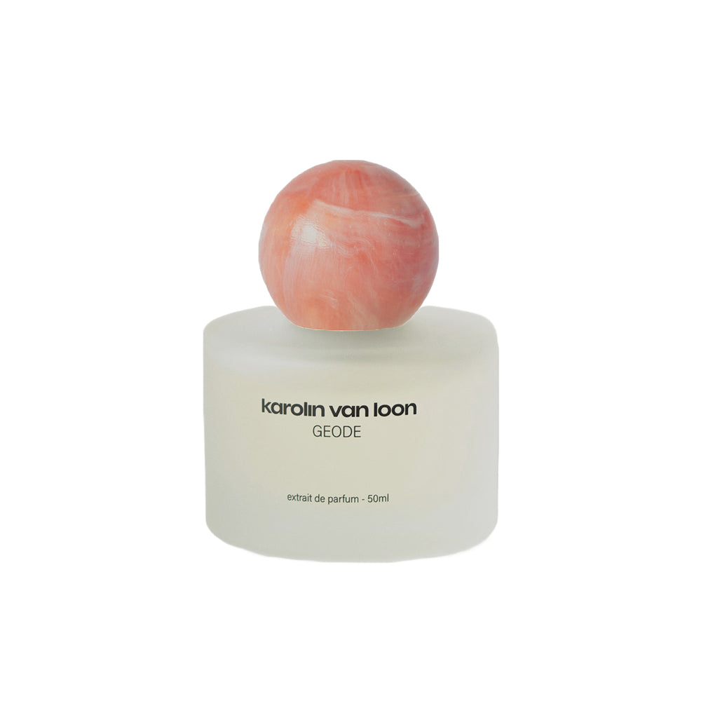 Perfume bottle with a marbled cap on a white background
