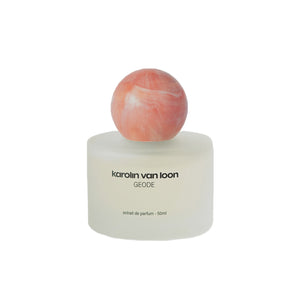 Perfume bottle with a marbled cap on a white background