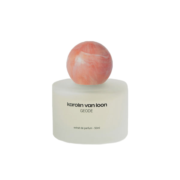 Perfume bottle with a marbled cap on a white background