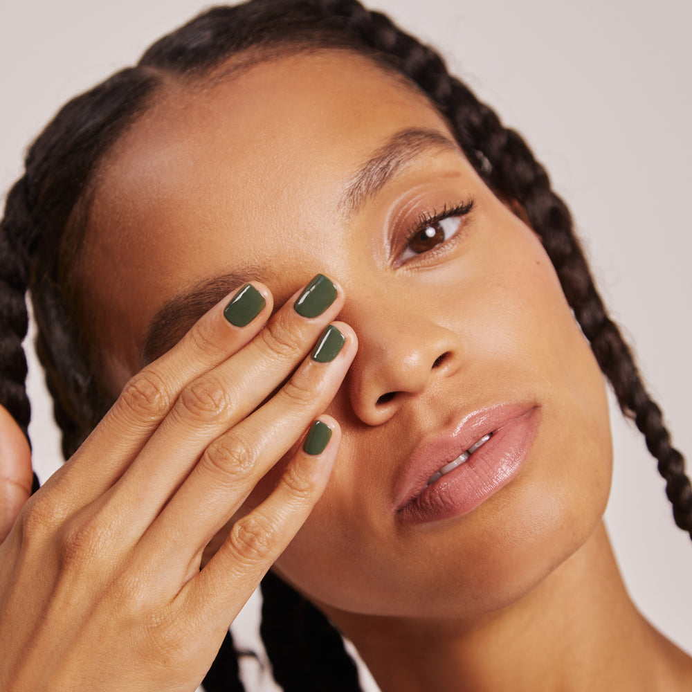 A tube of Karolin Van Loon lip gloss in Darling, showcasing a warm rosy brown hue that captures a glossy 90s vibe. This invigorating shade is perfect for elevating a bronzed latte makeup look, providing a radiant shine and moisturizing effect for fuller, more voluminous lips.