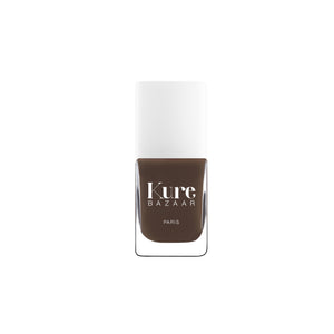 Brown nail polish bottle with 'Kure Bazaar' label on a white background