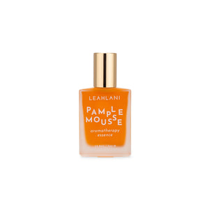 Leahlani Skincare Pamplemousse Aromatherapy Essence – citrus and tropical floral perfume oil in a glass bottle with notes of grapefruit, vanilla, plumeria, and guava.