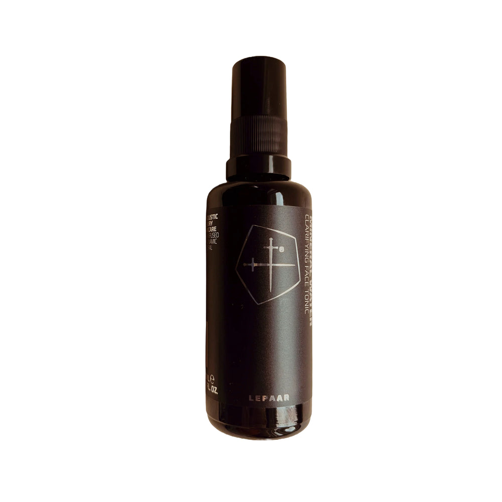 Black glass spray bottle with a logo on a white background. LEPAAR Even Lavender Mineral Water / Clarifying Face Tonic