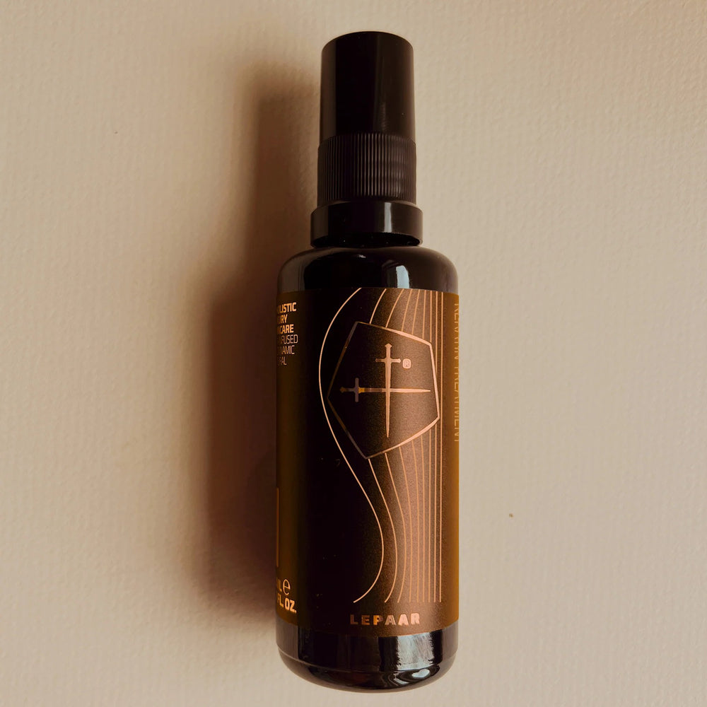 LEPAAR Lotus Light Perfumed Hair Oil in a glass bottle, featuring botanical ingredients for shine and nourishment.