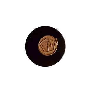 Round black object with a gold emblem on a white background. LEPAAR Luminous Beauty Balm / Ultra Restorative Moisture Lock