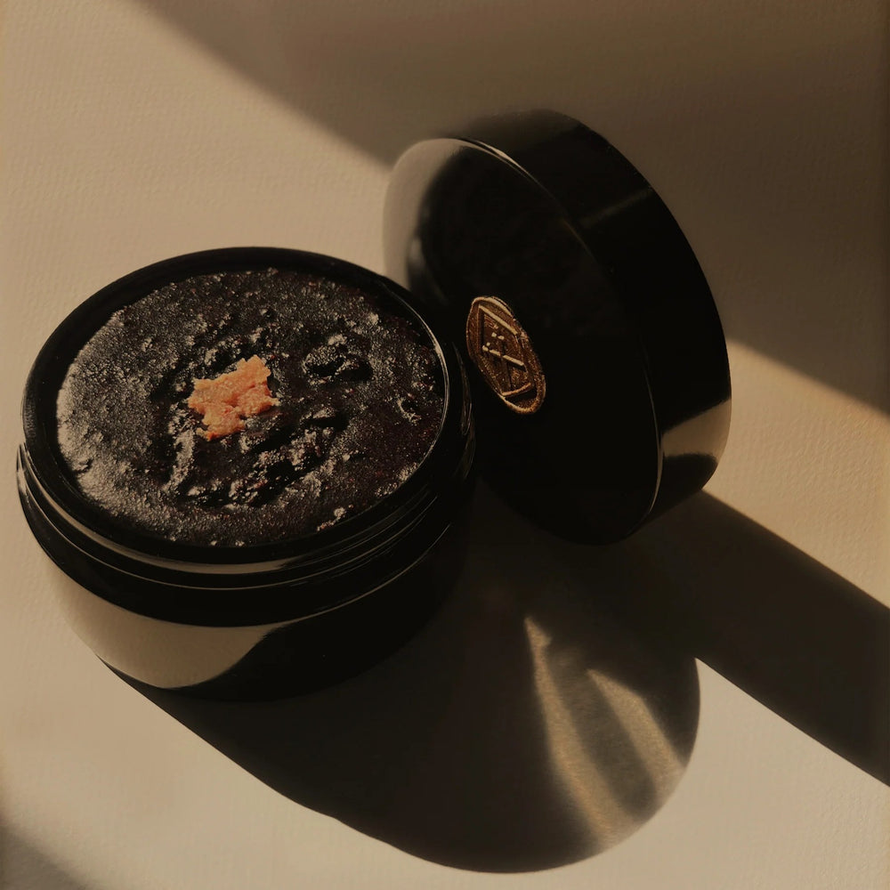 Jar of Lepaar Mandarin Mecca Coffee Scrub, a natural exfoliant with coffee grounds, coconut sugar, and botanicals, designed for gentle body and face exfoliation.