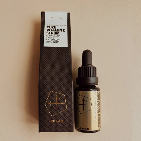 Yuzu Vitamin C Serum bottle and packaging on a beige background. LEPAAR Yuzu Vitamin C Serum Complexion Saving Antioxidant Concentrate