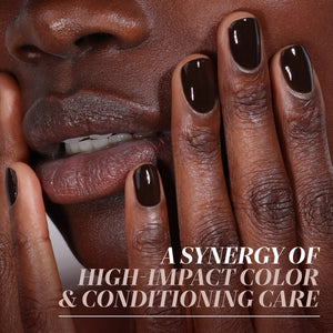 Close-up of a person's face with dark brown nails, with text overlay about high-impact color and conditioning care.