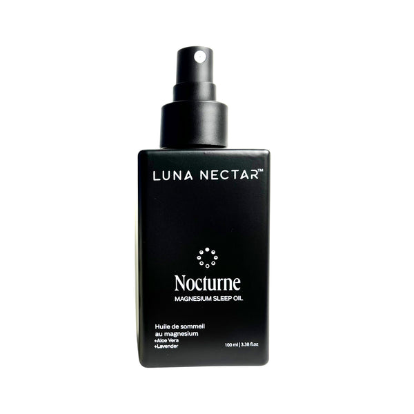 Black bottle of Luna Nectar Nocturne magnesium sleep oil on a white background
