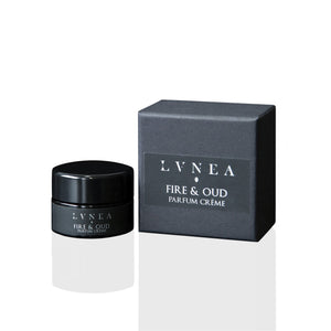 LVNEA Fire & Oud Parfum Crème in an amethyst glass pot— a smoky, woody solid perfume with notes of agarwood, cedar, incense, and warm resins, presented in a gift box.