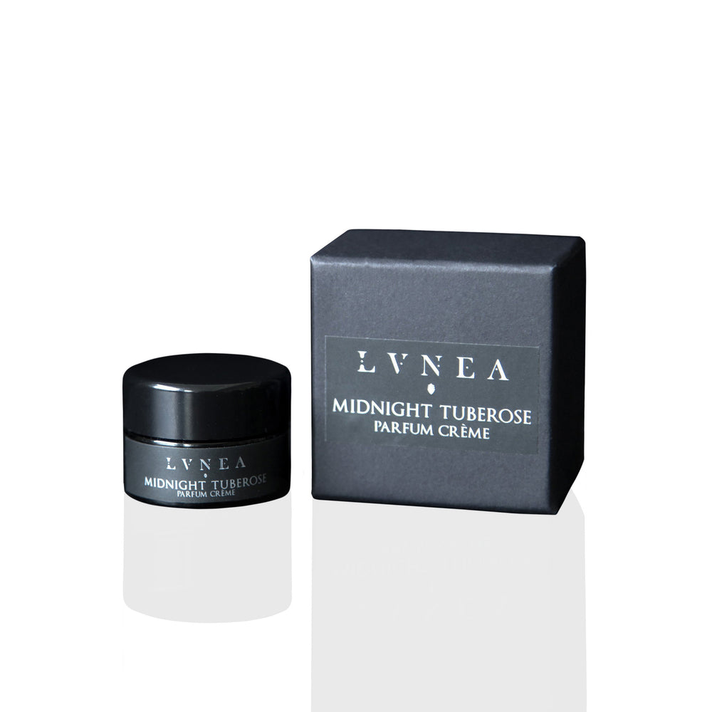 LVNEA Midnight Tuberose Parfum Crème in a 10g amethyst glass pot, nestled in a gift box. The solid perfume features notes of tuberose, rose, sandalwood, and a touch of cocoa, offering an enveloping, narcotic floral scent with resinous and wood undertones.