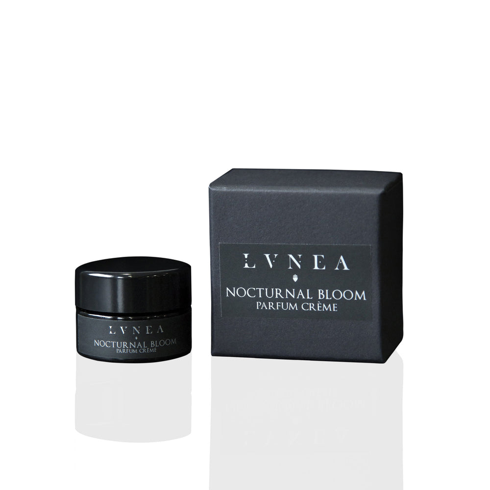 LVNEA Nocturnal Bloom Parfum Crème in an amethyst glass pot, featuring a blend of datura, osmanthus, and orange blossom. The solid perfume is nestled in a gift box, showcasing its luxurious, earthy, and spicy fragrance.