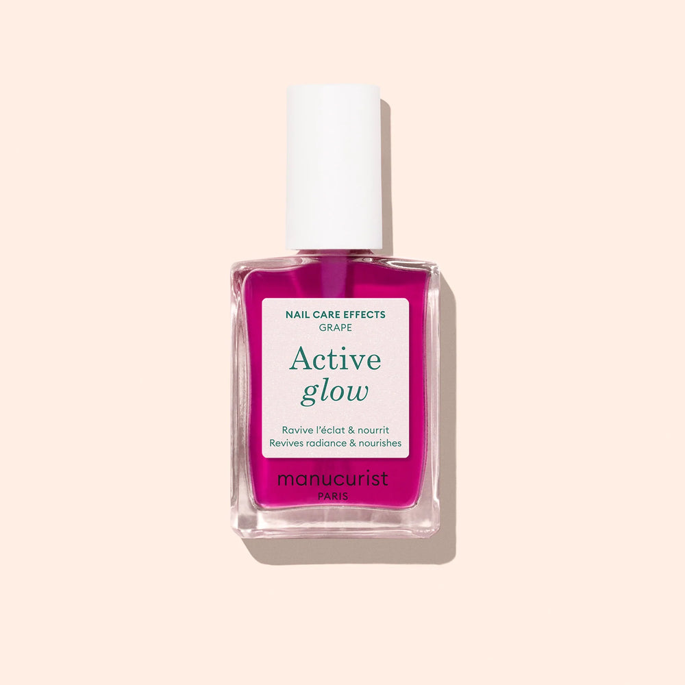 Bottle of MANUCURIST Active Glow™ Grape lilac nail polish with translucent shine and plant-based ingredients.