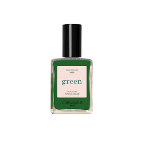 A bottle of Manucurist nail polish in the shade 'Jade', featuring an intense green color visible through the clear glass bottle, a light pink label, and a black cap, set against a plain white background.