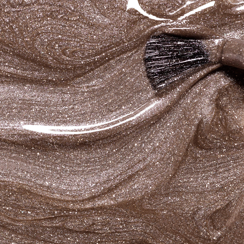 Bottle of MANUCURIST Green Flash™ Quartz semi-permanent nail polish in a glittery chestnut brown shade with taupe undertones and silver sparkle.