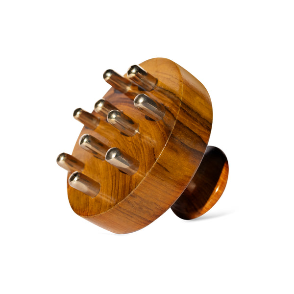 Wooden scalp massager with kansa nodes on a white background
