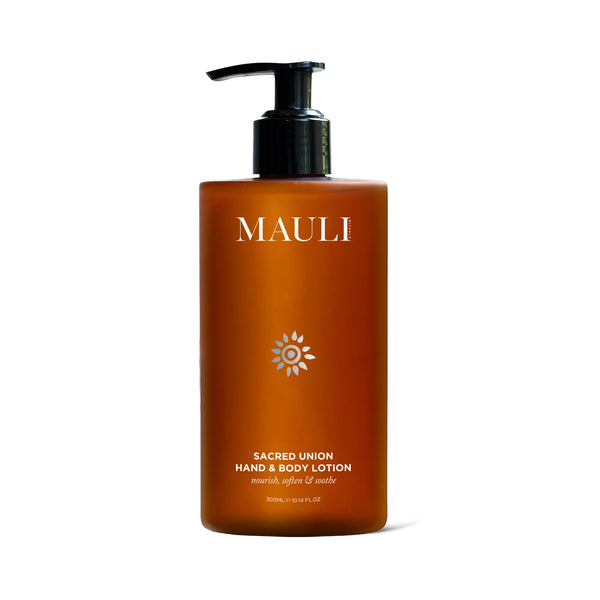 A dark orange bottle of MAULI RITUALS Sacred Union Hand & Body Lotion with black pump on white background