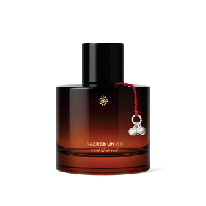 Brown bottle of MAULI RITUALS Sacred Union Scent & Dry Oil with a black cap on a white background