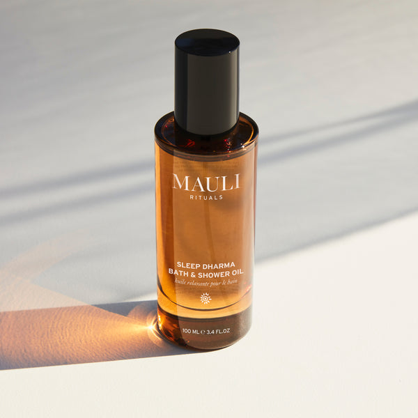 Bottle of MAULI Rituals Sleep Dharma Bath & Shower Oil on a light background