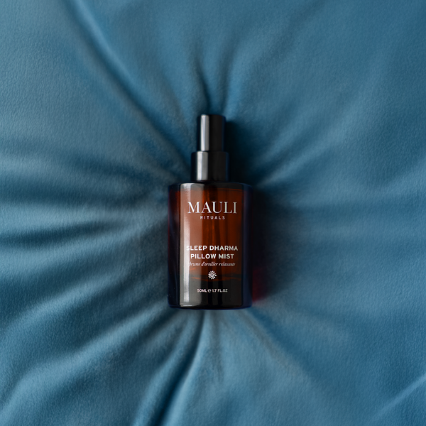 Mauli Rituals Sleep Dharma Pillow Mist bottle on a blue pillow