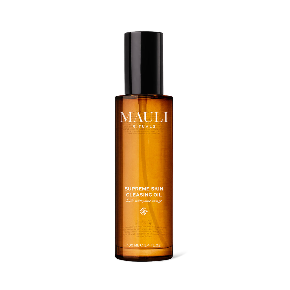 A glass amber bottle of MAULI RITUALS Supreme Skin Cleansing Oil on white background