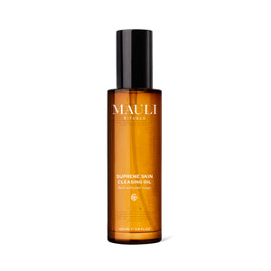 A glass amber bottle of MAULI RITUALS Supreme Skin Cleansing Oil on white background
