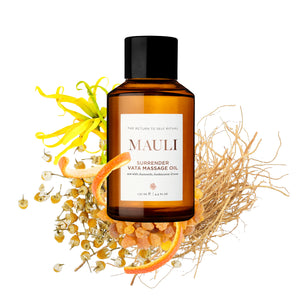 Bottle of MAULI RITUALS Surrender Vata Body Oill with natural elements on a white background