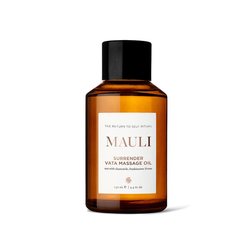 Amber glass bottle of MAULI RITUALS Surrender Vata Body Oil with a white label on a white background