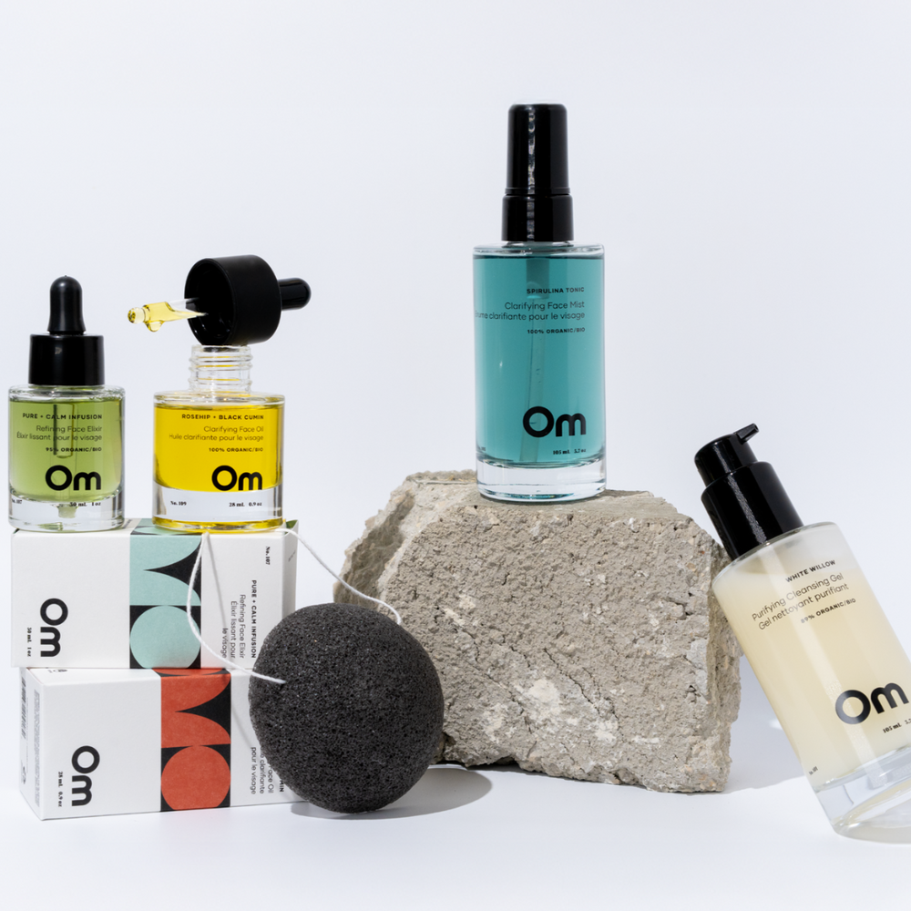 OM Organics Clarify and Balance skincare set featuring cleanser, face mist, elixir, face oil, and konjac sponge arranged together for oily and blemish-prone skin.