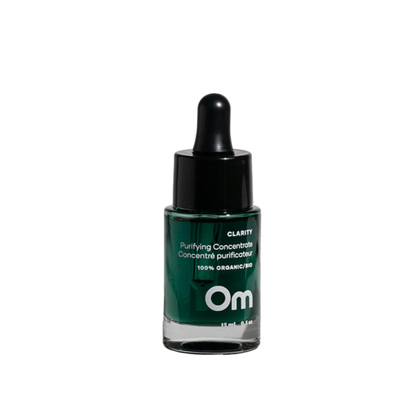 Om Organics Clarity Purifying Concentrate bottle with herbal scent notes of eucalyptus, lavender, lemon, and tea tree, crafted for blemish-prone and sensitive skin.